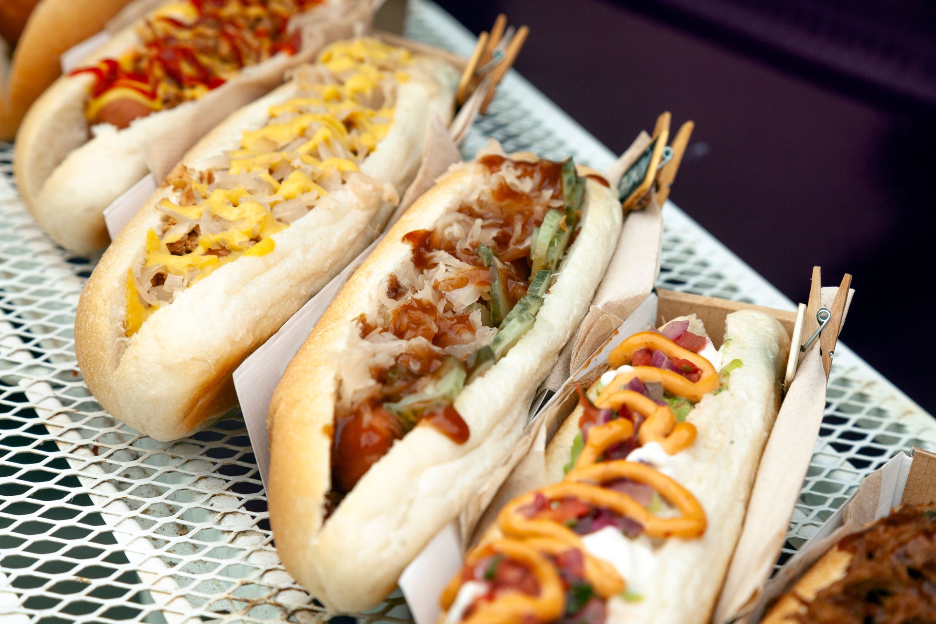 Fresh Hot dogs with sauce displayed in a row on food truck